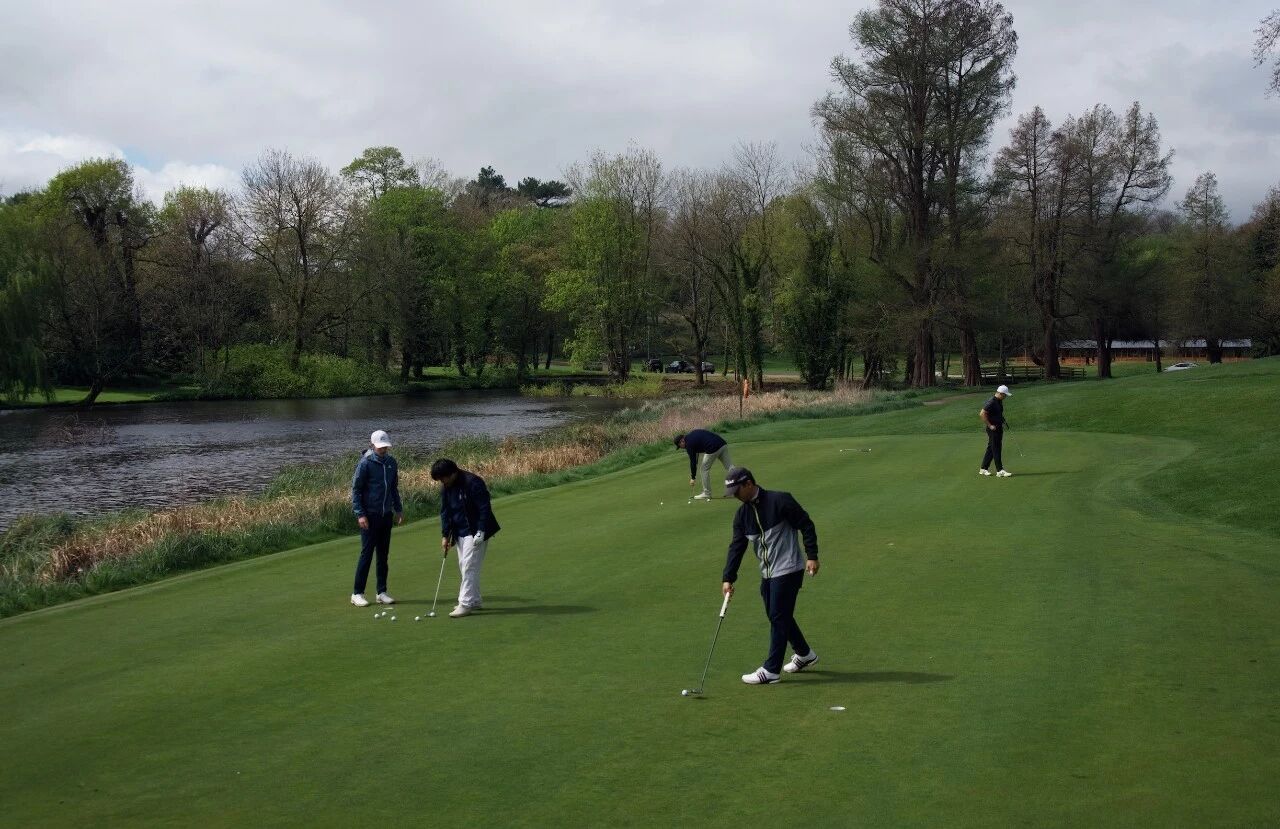 Members putting together on a riverside green